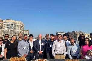 LaGuardia Community College students smile for a photo on a rooftop in Manhattan.